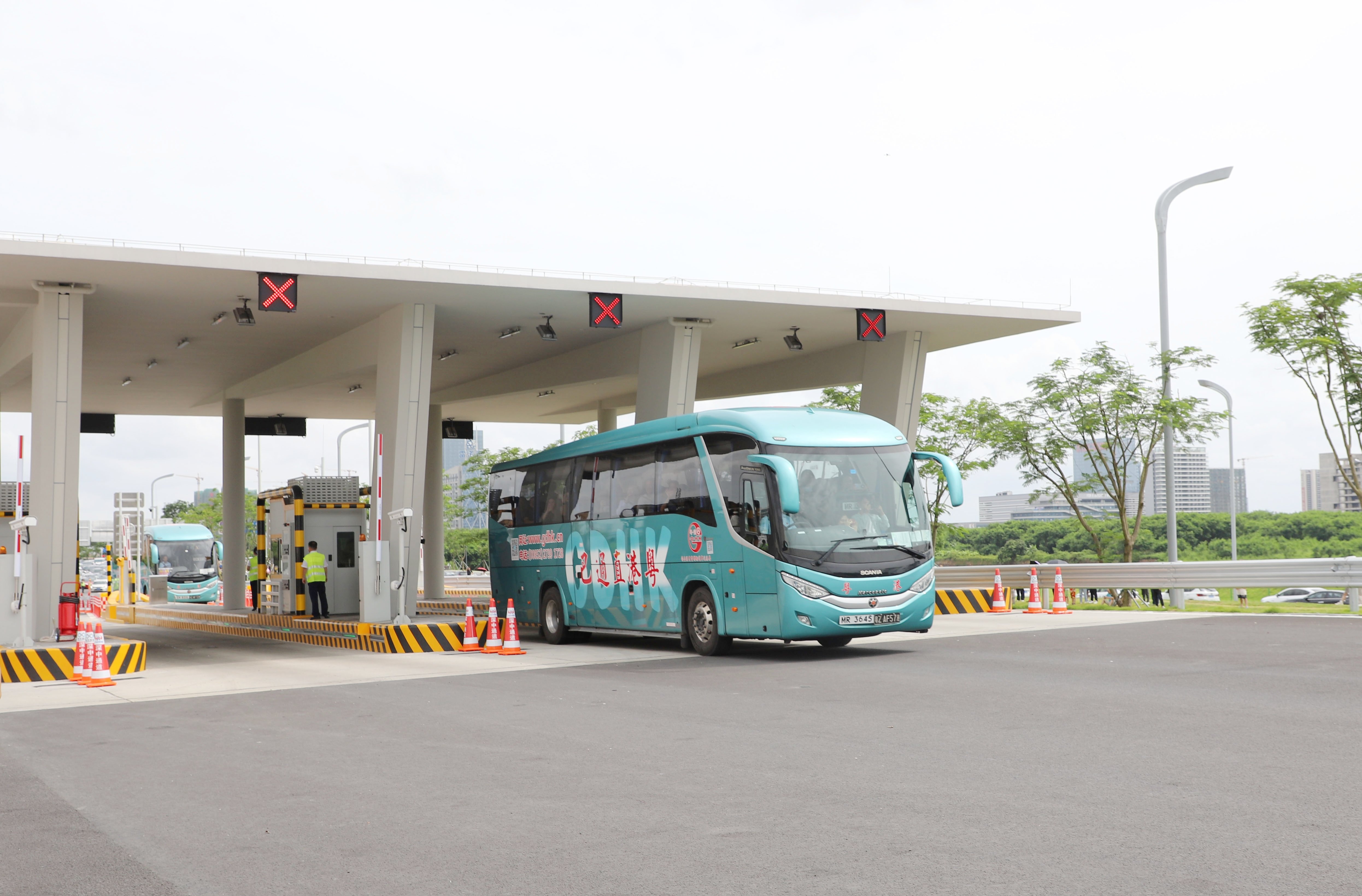 首輛粵港直通巴車駛出收費(fèi)站。人民網(wǎng) 何善福攝